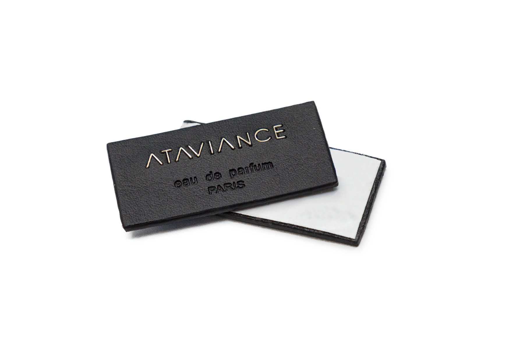 Selfadhesive leather and metal label to decorate perfume bottles